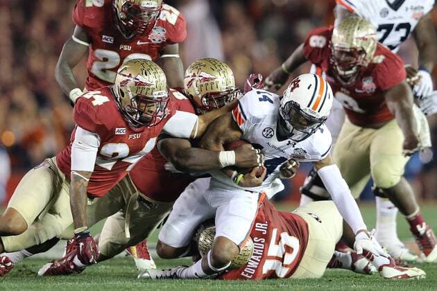 Jan. 6, 2014 - Pasadena, California, United States of America - Quarterback Nick Marshall 14 of the Auburn Tigers is sacked by defensive end Mario Edwards Jr. 15 of the Florida State Seminoles, assisted by linebacker Terrance Smith 24 of the Florida State Seminoles. During the BCS Championship Game in Pasadena, California. Between the 1 ranked Florida State Seminoles and the 2 ranked Auburn Tigers. The final game of the Bowl Championship Series, before moving to a four team playoff system. NCAA College League USA Football 2014 - Jan 6 - BCS Championship Game - Florida St vs Auburn - ZUMAl30