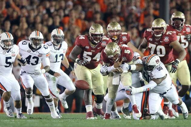 Jan. 6, 2014 - Pasadena, California, United States of America - Quarterback Jameis Winston 5 of the Florida State Seminoles is stripped of the ball by defensive lineman Angelo Blackson 98 of the Auburn Tigers, causing a fumble. During the BCS Championship Game in Pasadena, California. Between the 1 ranked Florida State Seminoles and the 2 ranked Auburn Tigers. The final game of the Bowl Championship Series, before moving to a four team playoff system. NCAA College League USA Football 2014 - Jan 6 - BCS Championship Game - Florida St vs Auburn - ZUMAl30