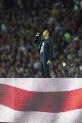 Jan. 6, 2014 - Pasadena, California, United States of America - Jonh Legend performs the National Anthem prior to the start of the BCS Championship Game in Pasadena, California. Between the 1 ranked Florida State Seminoles and the 2 ranked Auburn Tigers. The final game of the Bowl Championship Series, before moving to a four team playoff system. NCAA College League USA Football 2014 - Jan 6 - BCS Championship Game - Florida St vs Auburn - ZUMAl30