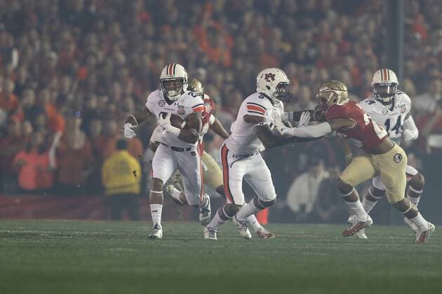 Jan. 6, 2014 - Pasadena, California, United States of America - Running back Tre Mason 21 of the Auburn Tigers, breaks through the Florida State line on the first play from scrimmage, during the BCS Championship Game in Pasadena, California. Between the 1 ranked Florida State Seminoles and the 2 ranked Auburn Tigers. The final game of the Bowl Championship Series, before moving to a four team playoff system. NCAA College League USA Football 2014 - Jan 6 - BCS Championship Game - Florida St vs Auburn - ZUMAl30