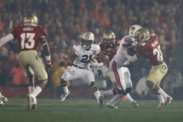 Jan. 6, 2014 - Pasadena, California, United States of America - Running back Tre Mason 21 of the Auburn Tigers, breaks through the Florida State line on the first play from scrimmage, during the BCS Championship Game in Pasadena, California. Between the 1 ranked Florida State Seminoles and the 2 ranked Auburn Tigers. The final game of the Bowl Championship Series, before moving to a four team playoff system. NCAA College League USA Football 2014 - Jan 6 - BCS Championship Game - Florida St vs Auburn - ZUMAl30