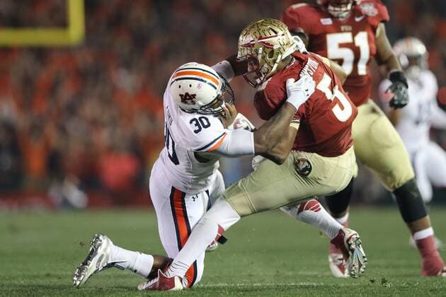 Jan. 6, 2014 - Pasadena, California, United States of America - Defensive end Dee Ford 30 of the Auburn Tigers, drags down and sacks, Quarterback Jameis Winston 5 of the Florida State Seminoles.During the BCS Championship Game in Pasadena, California. Between the 1 ranked Florida State Seminoles and the 2 ranked Auburn Tigers. The final game of the Bowl Championship Series, before moving to a four team playoff system. NCAA College League USA Football 2014 - Jan 6 - BCS Championship Game - Florida St vs Auburn - ZUMAl30