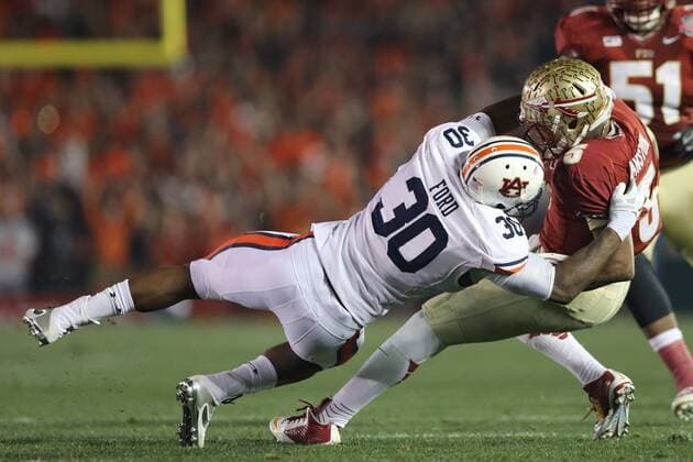 Jan. 6, 2014 - Pasadena, California, United States of America - Defensive end Dee Ford 30 of the Auburn Tigers, drags down and sacks, Quarterback Jameis Winston 5 of the Florida State Seminoles.During the BCS Championship Game in Pasadena, California. Between the 1 ranked Florida State Seminoles and the 2 ranked Auburn Tigers. The final game of the Bowl Championship Series, before moving to a four team playoff system. NCAA College League USA Football 2014 - Jan 6 - BCS Championship Game - Florida St vs Auburn - ZUMAl30