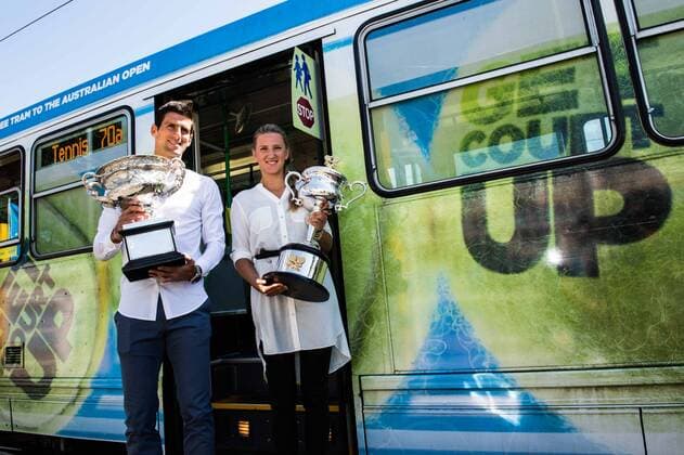 In this photo released by Tennis Australia, defending champions Victoria Azarenka (R) of Belarus and Novak Djokovic of Serbia posing with their trophies in front of a tram prior to the official draw of the Australian Open tennis championship in Melbourne, Australia, Jan. 10, 2014. (Xinhua) (SP)AUSTRALIA-MELBOURNE-TENNIS-AUSTRALIA OPEN-DRAW 
