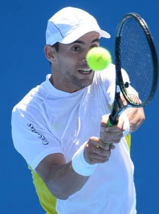 (140113) -- MELBOURNE, Jan. 13, 2014 (Xinhua) -- Colombia s Santiago Giraldo plays a shot during his men s singles match on day one of the 2014 Australian Open tennis tournament in Melbourne on January 13, 2014. (Xinhua Li Jundong) (SP)AUSTRALIA-MELBOURNE-TENNIS-AUSTRALIA OPEN 