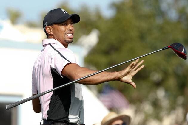 Jan. 23, 2014 - La Jolla, California, U.S - Tiger Woods reacts after hitting an errant shot off the 9th tee during the first round of the Farmers Insurance Open golf tournament at Torrey Pines Municipal Golf Course. Farmers Insurance Open - Round 1 - ZUMAw10