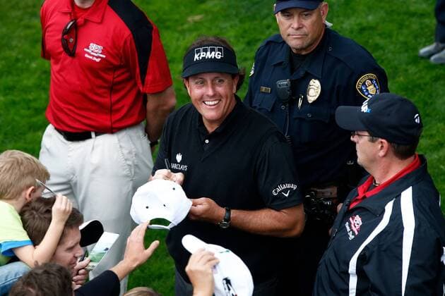 Jan. 24, 2014 - La Jolla, California, U.S - Phil Mickelson signs autographs for fans after the second round of the Farmers Insurance Open golf tournament at Torrey Pines Municipal Golf Course. Farmers Insurance Open - Round 2 - ZUMAw10