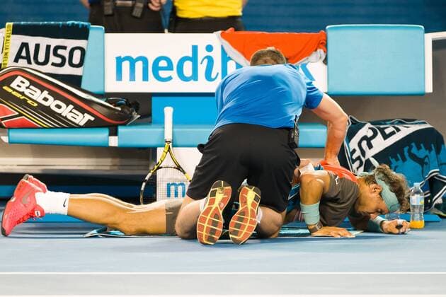 Jan. 26, 2014 - Melbourne, Victoria, Australia - January 26, 2014: 1st seed Rafael NADAL (ESP) receives treatment against 8th seed Stanislas WAWRINKA (SUI) in the Men s Final on day 14 of the 2014 Australian Open grand slam tennis tournament at Melbourne Park in Melbourne, Australia. Sydney Tennis 2014: Australian Open JAN 26 - ZUMAc04