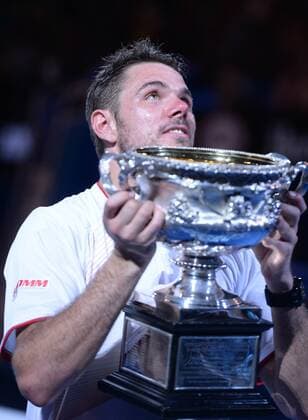 Stanislas Wawrinka of Switzerland reacts during the awarding ceremony after his men s singles final match at 2014 Australian Open tennis tournament in Melbourne, Australia, Jan. 26, 2014. (Xinhua Li Jundong) (SP)AUSTRALIA-MELBOURNE-TENNIS-MEN S SINGLES-FINAL-CEREMONY 