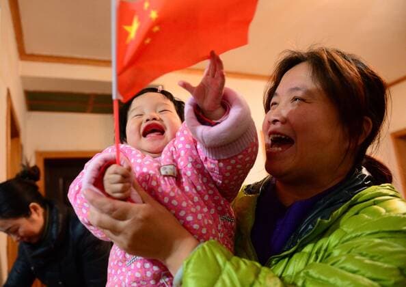 WUHAN, CHINA - JANUARY 25: (CHINA OUT) Li Na s niece, 9-month-old, holds a Chinese flag at home on January 25, 2014 in Wuhan, Hubei Province of China.  CFP1547 