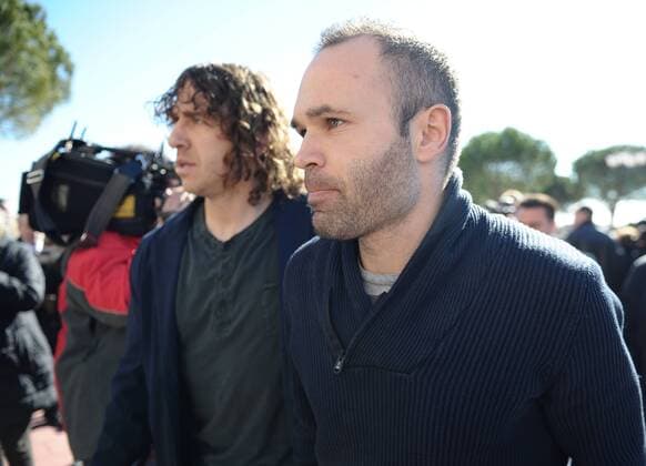 FC Barcelona s players Carles Puyol and Andres Iniesta during the funeral ceremony in memory of the national soccer team coach Luis Aragones. February 2, 2014.  (1608377)