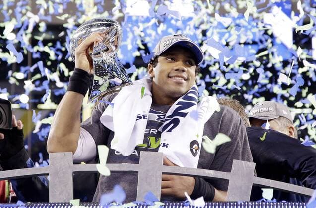 Seattle Seahawks quarterback Russell Wilson holds the Vince Lombardi trophy after winning Super Bowl XLVIII at MetLife Stadium in East Rutherford, New Jersey on February 2, 2014. Seattle beat Denver 43-8 to win the Super Bowl.  SBP20140202354