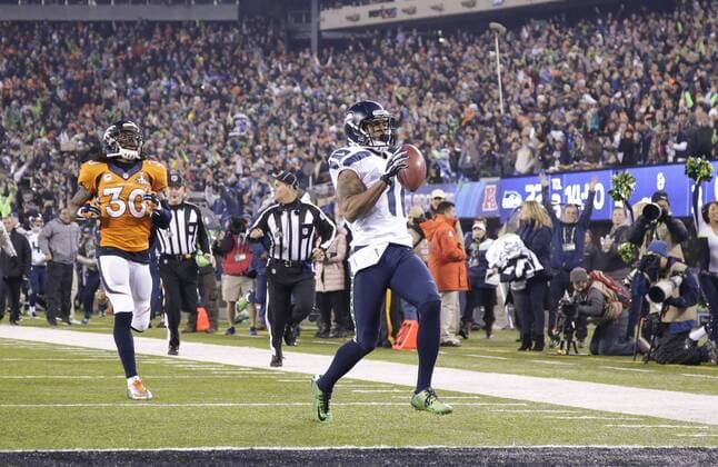 Seattle Seahawks kick returner Percy Harvin returns a kick off 87 yards for a touchdown against the Denver Broncos to start the third quarter of Super Bowl XLVIII at MetLife Stadium in East Rutherford, New Jersey on February 2, 2014. MetLife Stadium hosts the NFL s first outdoor cold weather Super Bowl. Seattle beat Denver 43-8 to win the Super Bowl.  SBP20140202353