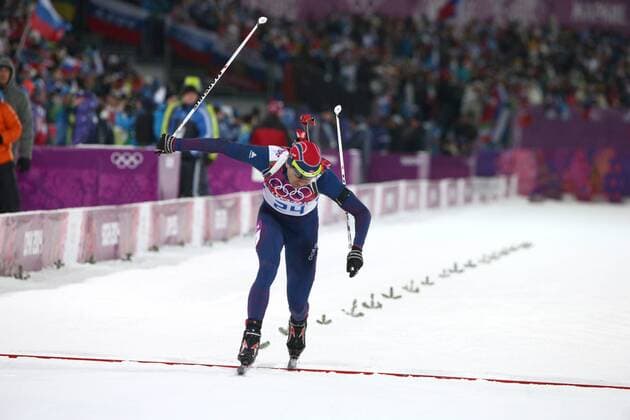 ITAR-TASS: SOCHI, RUSSIA. FEBRUARY 8, 2014. Biathlete Ole Einar Bjoerndalen of Norway crosses the finish line as he wins the men s 10 km sprint at the Sochi 2014 Winter Olympics, at Laura biathlon & ski complex.  premiumd RE13862E