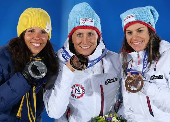 ITAR-TASS: SOCHI, RUSSIA. FEBRUARY 8, 2014. Silvermedalist Charlotte Kalla of Sweden, goldmedalist Marit BjÃ¶rgen of Norway, and bronzemedalist Heidi Weng of Norway (L-R) pose during the victory ceremony for the women s cross-country skiathlon 7,5 km in classic style and 7,5 km in freestyle event at the Sochi 2014 Olympic Games.  RE13873E