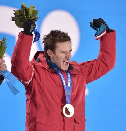 Austria s Matthias Meyer celebrates after being presented with the gold medal during the victory ceremony for Men s Downhill Ski in the Sochi 2014 Winter Olympics on February 9, 2014 in Sochi.  OLY20140209157