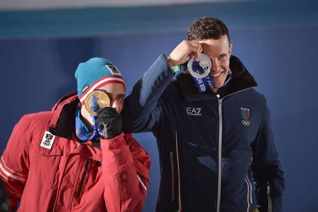 ItalyÕs Christof Innerhoffer (R) and AustriaÕs Matthias Meyer stand together after being presented with the gold and silver medals respectively in MenÕs Downhill Skiing during a victory ceremony at the Sochi 2014 Winter Olympics on February 9, 2014 in Sochi.  OLY20140209163