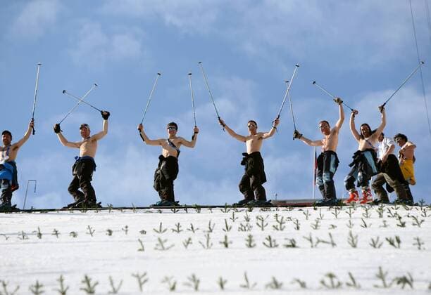 Feb. 10, 2014 - Sochi, Russia - Course workers take off their shirts to enjoy the warm weather as they prepare the landing hill before the Men s Nordic Combined Normal Hill training jump at the RusSki Gorki Jump Center at the 2014 Sochi Winter Olympics. The snow was too warm and one training jump was cancelled due to slushy conditions. Men s Nordic Combined - Sochi 2014 - ZUMAsc5