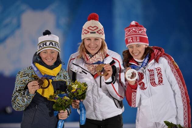 Russia s Olga Vilukhina (R-L), Slovokia s Anastasiya Kuzmina, and Ukraine s Vita Semerenko hold their silver, gold and bronze medals during the victory ceremony for the Biathalon Women s Sprint at the Sochi 2014 Winter Olympics on February 10, 2014 in Sochi, Russia.  OLY20140210134