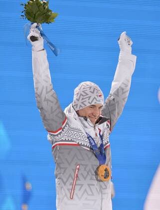 Poland s Kamil Stoch celebrates after he was presented a gold medal during the victory ceremony for men s individual normal hill ski jumping at the Sochi 2014 Winter Olympics on February 10, 2014 in Sochi, Russia.  OLY20140210139