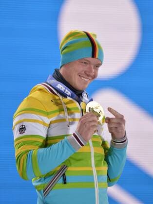 Germany s Felix Loch points to his gold medal during the victory ceremony for men s luge singles at the Sochi 2014 Winter Olympics on February 10, 2014 in Sochi, Russia.  OLY20140210146