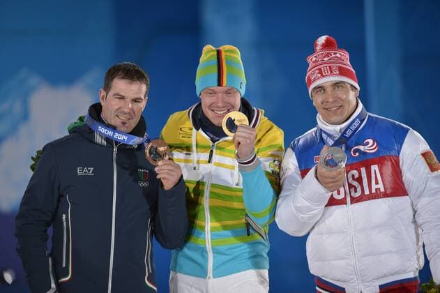 Russia s Albert Demchenko (R-L), Germany s Felix Loch and Italy s Armin Zöggeler hold their silver, gold and bronze medals during the victory ceremony for men s luge singles at the Sochi 2014 Winter Olympics on February 10, 2014 in Sochi, Russia.  OLY20140210150