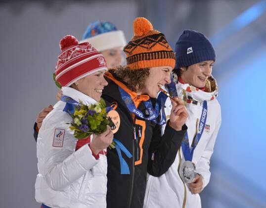 The Czech Republic s Martina Sablikova (R-L), the Netherland s Ireen Wüst and Russia s Olga Graf stand with their silver, gold and bronze medals during the victory ceremony for ladies 3000M speed skating at the Sochi 2014 Winter Olympics on February 10, 2014 in Sochi, Russia.  OLY20140210161