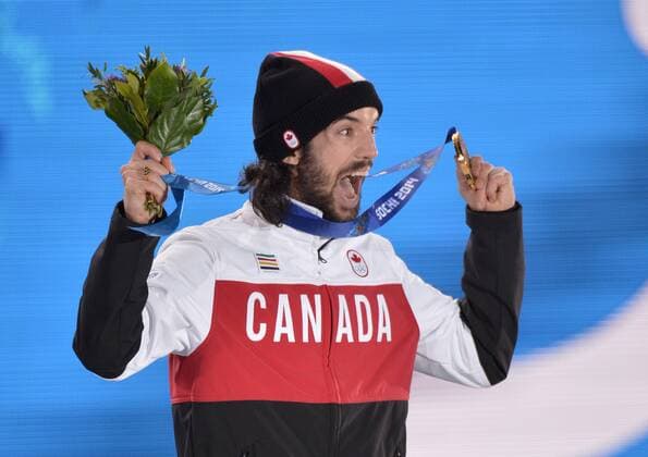 Canada s Charles Hamelin celebrates with his gold medal during the victory ceremony for the men s 1500M short track speed skating at the Sochi 2014 Winter Olympics on February 10, 2014 in Sochi, Russia.  OLY20140210169