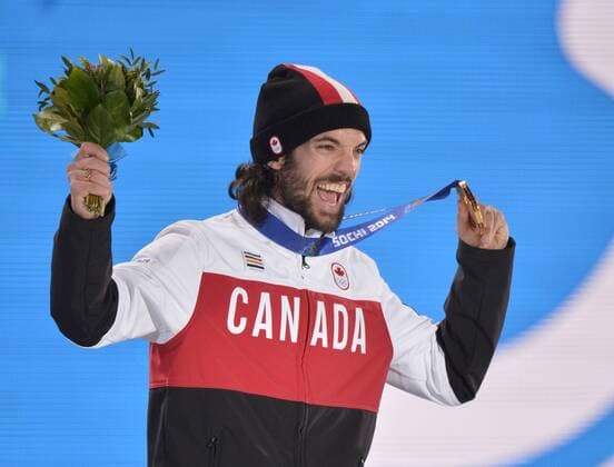 Canada s Charles Hamelin celebrates with his gold medal during the victory ceremony for the men s 1500M short track speed skating at the Sochi 2014 Winter Olympics on February 10, 2014 in Sochi, Russia.  OLY20140210170