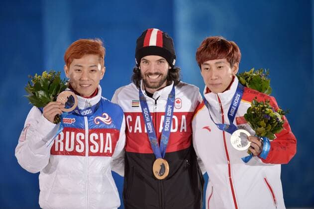 China s Han Tianyu (R-L), Canada s Charles Hamelin and Russia s Victor An pose for a photo with their silver, gold and bronze medals during the victory ceremony for the men s 1500M short track speed skating at the Sochi 2014 Winter Olympics on February 10, 2014 in Sochi, Russia.  OLY20140210173