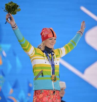 Germany s Maria HÖFL RIESCH celebrates after being presented with a gold medal during the victory ceremony for alpine ladies super combined at the Sochi 2014 Winter Olympics on February 10, 2014 in Sochi, Russia.  OLY20140210181