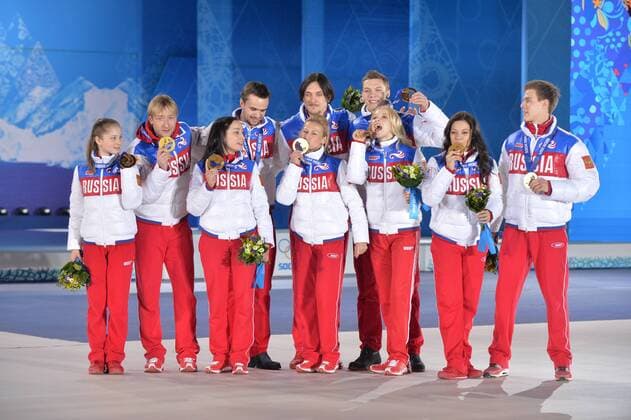Russia s team poses for a photo with their gold medals during the victory ceremony for the figure skating team event at the Sochi 2014 Winter Olympics on February 10, 2014 in Sochi, Russia.  OLY20140210200