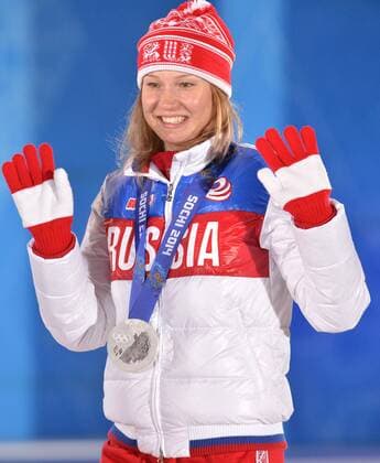 Silver medalist, Russia s Olga Fatkulina, celebrates during the victory ceremony for the ladies speed skating 500m at the Sochi 2014 Winter Olympics on February 12, 2014 in Sochi, Russia.  OLY20140212344