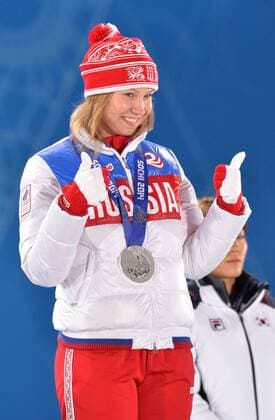 Silver medalist, Russia s Olga Fatkulina, celebrates during the victory ceremony for the ladies speed skating 500m at the Sochi 2014 Winter Olympics on February 12, 2014 in Sochi, Russia.  OLY20140212349