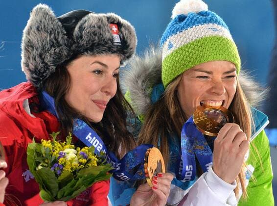 Tying gold medalist, Switzerland s Dominique Gisin (L) and Slovakia s Time Maze pose with their medals during the victory ceremony for ladies downhill, at the Sochi 2014 Winter Olympics on February 12, 2014 in Sochi, Russia.  OLY20140212366