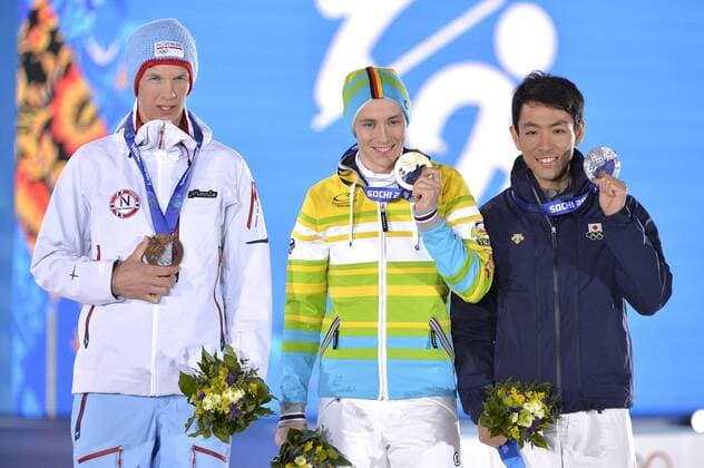 Japan s Akito Watabe, Germany s Eric Frenzel and Norway s Magnus Krog stand with their bronze, gold and silver medals during the victory ceremony for 10km nordic combined individual Gunderson NH at the Sochi 2014 Winter Olympics on February 13, 2014 in Sochi, Russia.  OLY20140213405