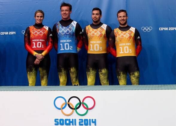 ITAR-TASS: SOCHI, RUSSIA. FEBRUARY 14, 2014. Gold medalists, Germany s Natalie Geisenberger, Felix Loch, Tobias Wendl and Tobias Arlt (L-R) pose at a flower ceremony following the Luge Team Relay competition at the 22nd Winter Olympic Games in Sochi, at the Sanki Sliding Center.  RE1392BF