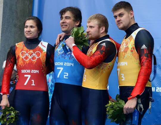 ITAR-TASS: SOCHI, RUSSIA. FEBRUARY 14, 2014. Silver medalists, Russia s Tatyana Ivanova, Albert Demchenko, Vladislav Antonov and Alexander Denisyev (L-R) pose at a flower ceremony following the Luge Team Relay competition at the 22nd Winter Olympic Games in Sochi, at the Sanki Sliding Center.  RE1392D0