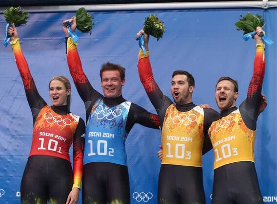 ITAR-TASS: SOCHI, RUSSIA. FEBRUARY 14, 2014. Gold medalists, Germany s Natalie Geisenberger, Felix Loch, Tobias Wendl and Tobias Arlt (L-R) pose at a flower ceremony following the Luge Team Relay competition at the 22nd Winter Olympic Games in Sochi, at the Sanki Sliding Center.  RE1392D1