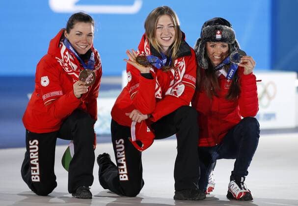 (140215) -- SOCHI, Feb. 15, 2014 (Xinhua) -- Gold medalist Darya Domracheva (C) of Belarus, silver medalist Selina Gasparin(R) of Switzerland and bronze medalist Madezhda Skardino of Belarus pose during the awarding ceremony for the women s 15km individual of Biathlon at the 2014 Sochi Winter Olympic Games in Sochi, Russia, Feb. 15, 2014. (Xinhua Wang Lili) (SP)OLY-RUSSIA-SOCHI-BIATHLON-WOMEN S 15KM INDIVIDUAL 