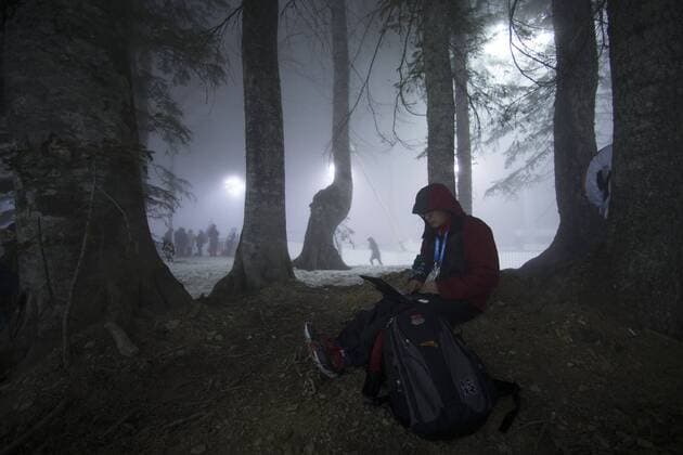 (140216) -- SOCHI, Feb. 16, 2014 (Xinhua) -- A reporter works in the fog ahead of Men s Biathlon 15 km Mass Start at the Laura Cross-Country Ski and Biathlon Center during the Sochi Winter Olympics on February 16, 2014. The race was postponed due to heavy fog. (Xinhua Fei Maohua) (SP)OLY-RUSSIA-SOCHI-BIATHLON-MEN S 15KM MASS START-WEATHER 