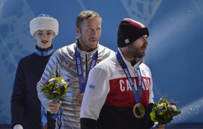 United States Bode Miller (C) and Canada s Jan Hudec (R) walk of the stage after the victory ceremony for alpine skiing men s Super G at the Sochi 2014 Winter Olympics on February 16, 2014 in Sochi, Russia. Miller and Hudec tied for a bronze medal in the event.  OLY20140216160