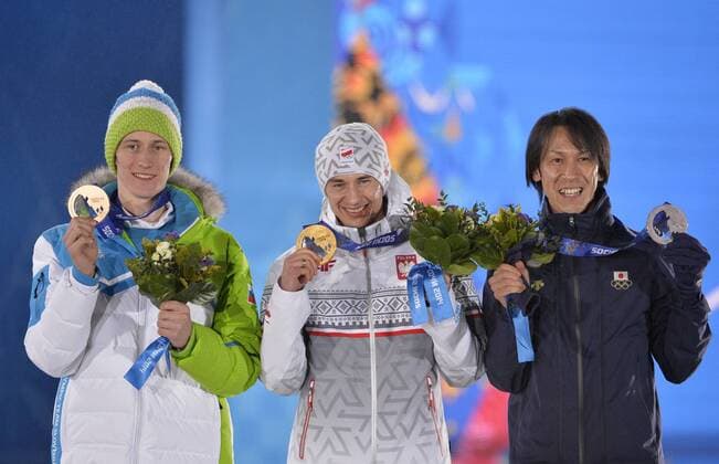 Slovania s Peter Prevc, Poland s Kamil Stoch and Japan s Noriaki Kasai celebrate their bronze, gold and silver medals respectively, during the victory ceremony for ski jumping men s large hill individual at the Sochi 2014 Winter Olympics on February 16, 2014 in Sochi, Russia.  OLY20140216736