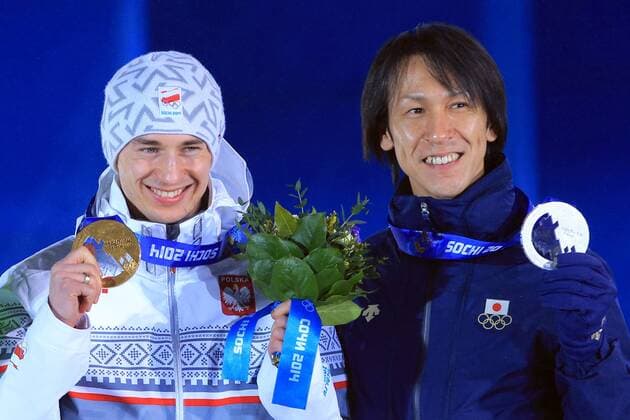 ITAR-TASS: SOCHI, RUSSIA. FEBRUARY 16, 2014. Gold medalist Kamil Stoch of Poland (L) and silver medalist Noriaki Kasai of China pose with their medals at a victory ceremony for the men s large hill ski jump event at the Sochi 2014 Winter Olympic Games, at Medals Plaza.  RE139B70