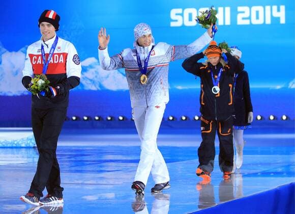 ITAR-TASS: SOCHI, RUSSIA. FEBRUARY 16, 2014. Canadian Denny Morrison (Bronze), Polish Zbigniew Brodka (Gold) and Dutch Koen Verweij (Silver), from left to right, at a victory ceremony for the men s 1500 metres speed skating event at the Sochi 2014 Winter Olympic Games, at Medals Plaza.  RE139BA3
