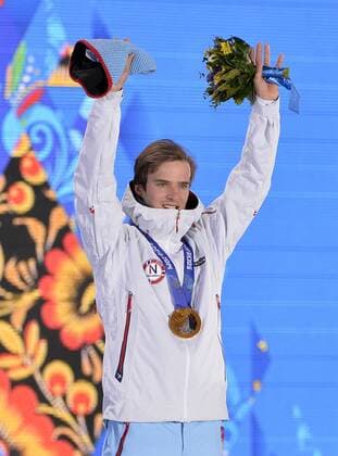 Norway s Joergen Graabak celebrates during the victory ceremony for nordic combined individual Gunderson long hill 10km at the Sochi 2014 Winter Olympics on February 19, 2014 in Sochi, Russia. Graabak won a gold medal in the event.  OLY20140219134