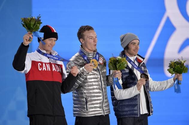 Canada s Mike Riddle, United States David Wise and France s Kevin Rolland pose for photos during the victory ceremony for men s freestyle ski half pipe at the Sochi 2014 Winter Olympics on February 19, 2014 in Sochi, Russia. Riddle won silver, Wise gold and Rolland bronze in the event.  OLY20140219146