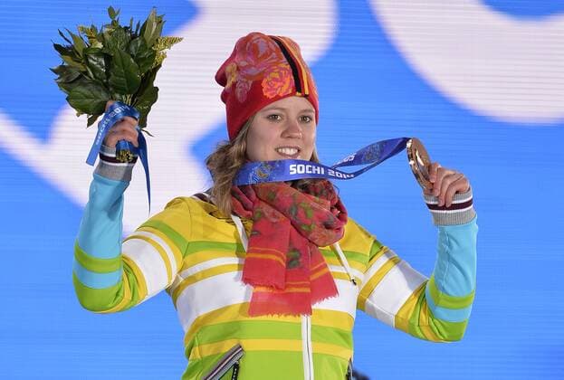 Germany s Viktoria Rebensburg holds up her bronze medal during the victory ceremony for ladies alpine skiing giant slalom at the Sochi 2014 Winter Olympics on February 19, 2014 in Sochi, Russia.  OLY20140219117