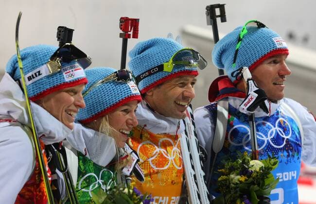 ITAR-TASS: SOCHI, RUSSIA. FEBRUARY 19, 2014. Gold medalists Tora Berger, Tiril Eckhoff, Ole Einar Bjoerndalen and Emil Hegle Svendsen of Norway (L-R) pose during the flower ceremony in the mixed biathlon relay event at the Laura Ski Centre at the 22nd Winter Olympic Games.  RE13A366