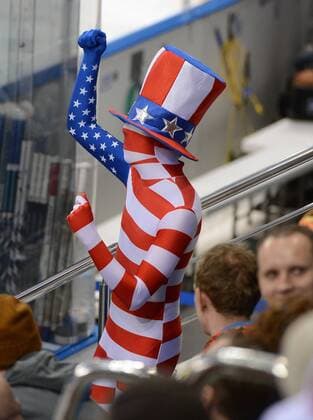 Feb. 19, 2014 - Sochi - A fan dressed in an American flag body suit dances during a break in the third period in a Winter Olympics quarterfinal game at Shayba Arena in Sochi, Wednesday, Feb. 19, 2014. - ZUMAm67